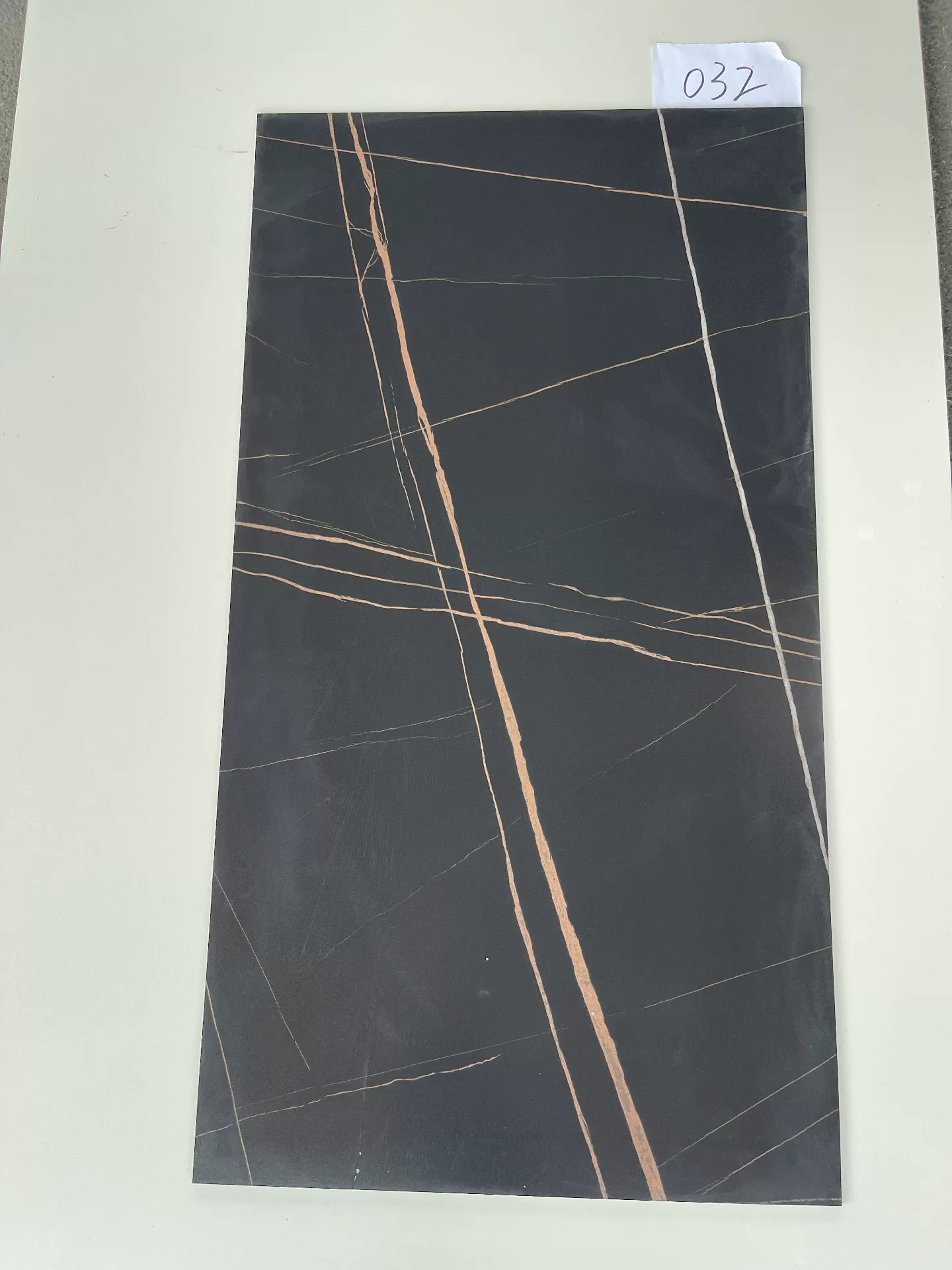 Sintered stone slab black gold pattern sample