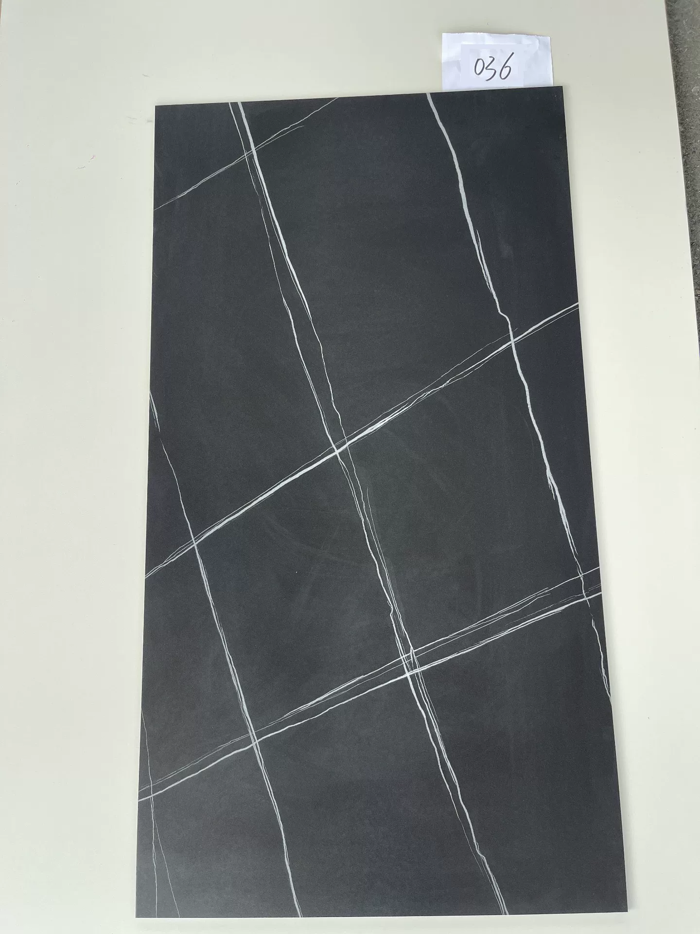 Sintered stone slab black gold pattern close-up